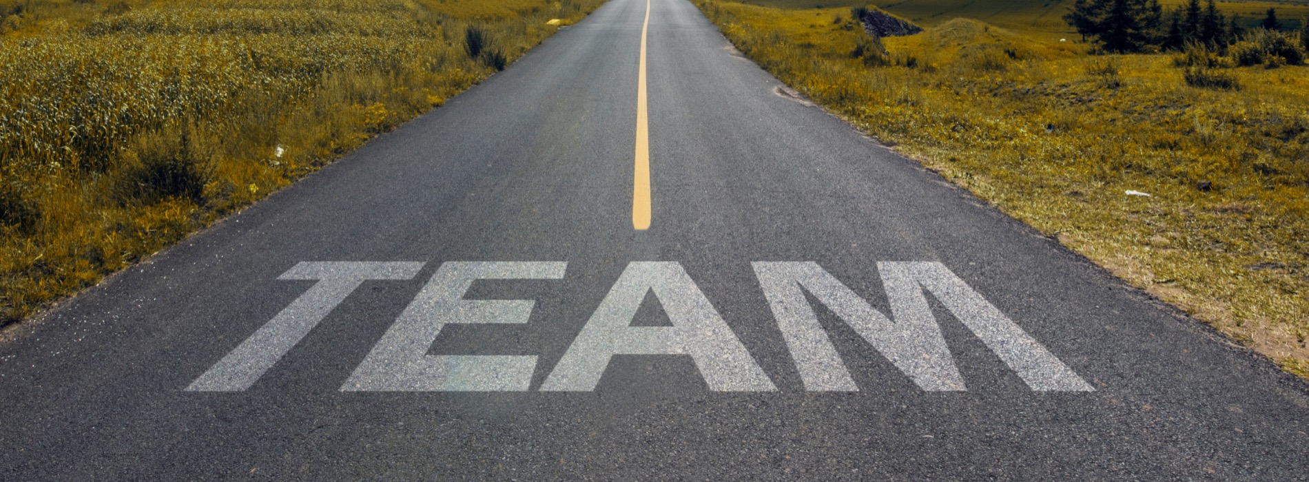 Careers - Photo of road with word "Team" on roadway for driver to read